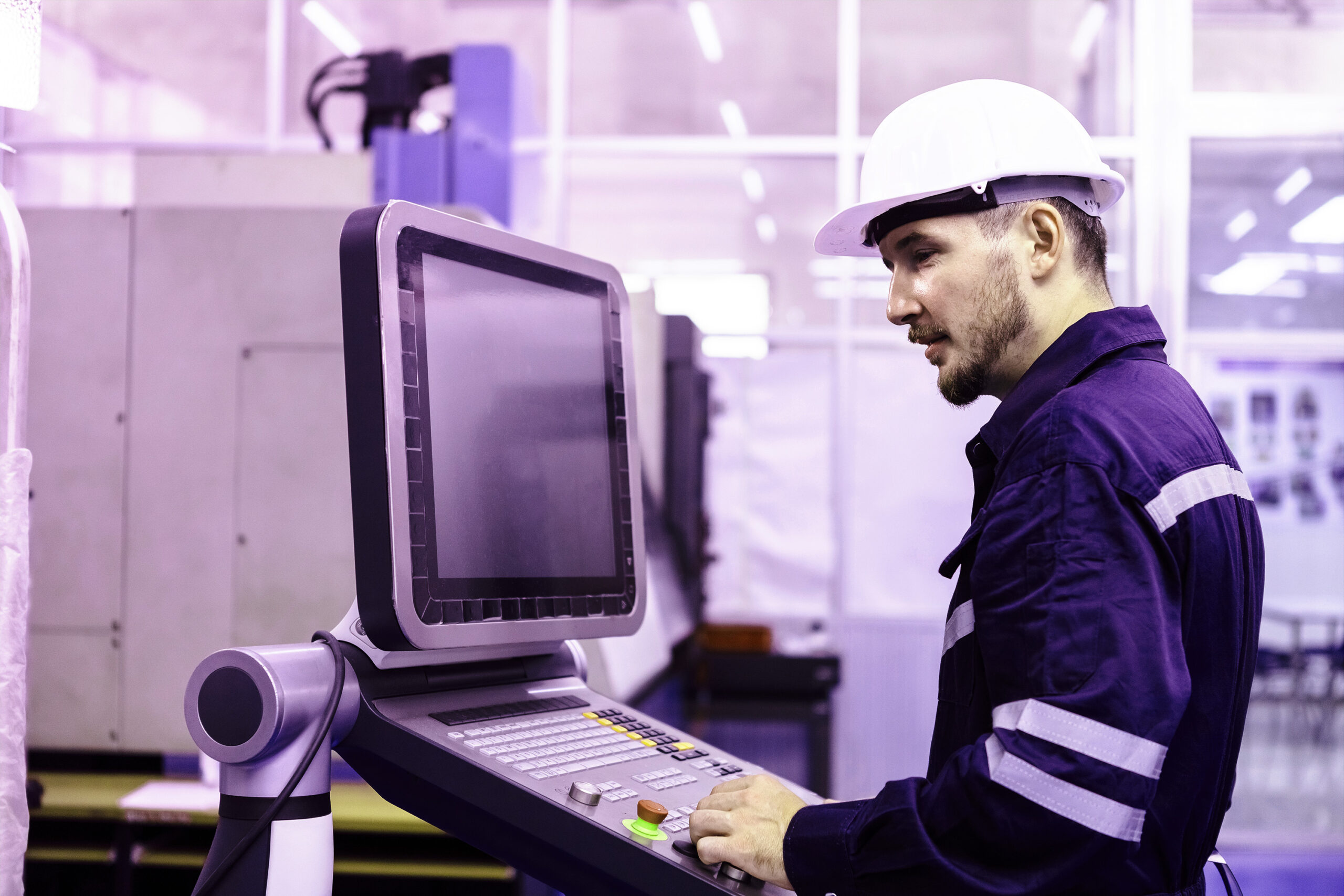 engineer controlling machine in a factory